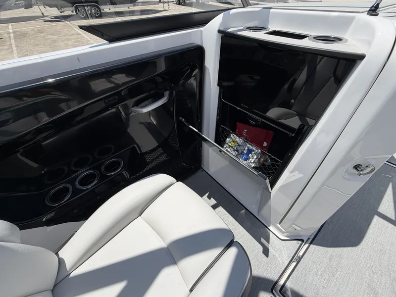 Slide: The Image of Interior of 2024 Yamaha Boats AR250 with storage and seating area. - 20