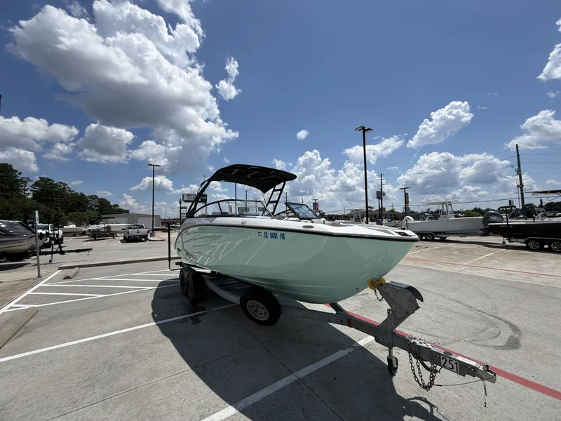 Slide: The Image of 2024 Yamaha AR250 boat on trailer under blue sky. - 6