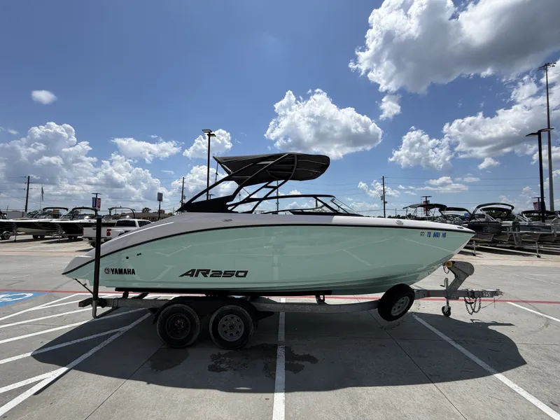 Slide: The Image of 2024 Yamaha AR250 boat on trailer under blue sky. - 7