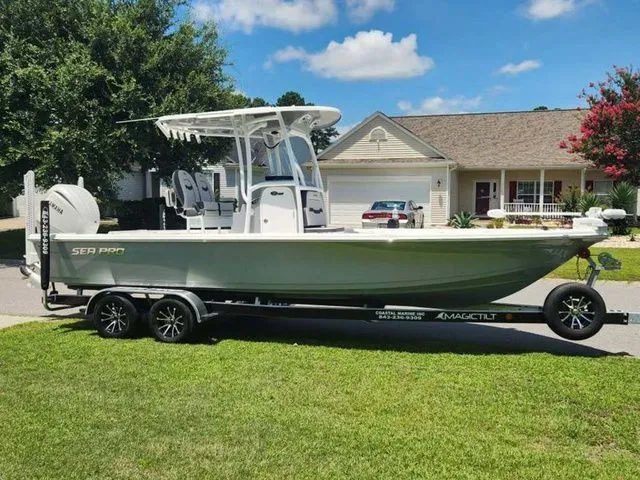 The Image of 2026 Sea Pro 250 Bay boat on trailer in front of house. - 1