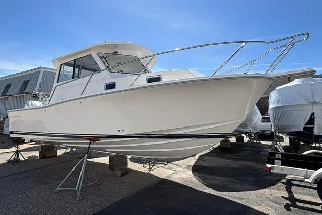 The Image of 2026 NorthCoast 285 HT boat on stands, displayed outdoors under clear blue sky. - 0