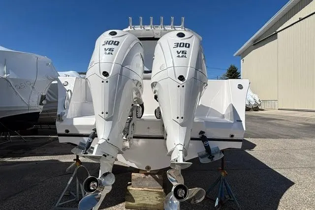 Slide: The Image of 2026 NorthCoast 285 HT boat with dual 300 V6 outboard engines, docked outdoors. - 2