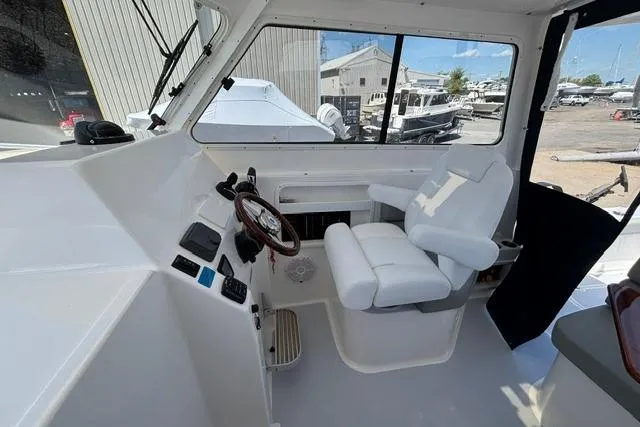 Slide: The Image of 2026 NorthCoast 285 HT boat interior with helm station and captain's chair. - 6