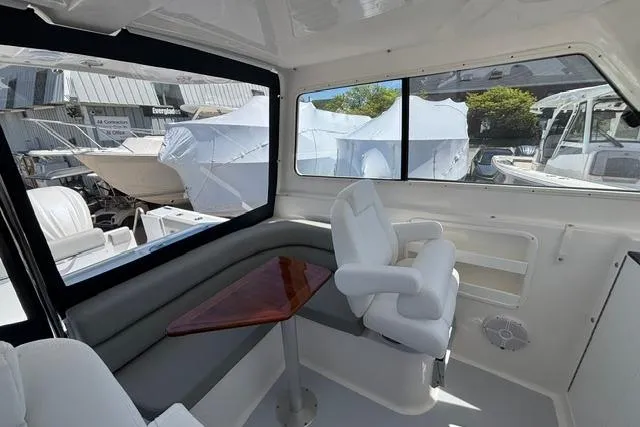 Slide: The Image of Interior of 2026 NorthCoast 285 HT boat with seating and table. - 7