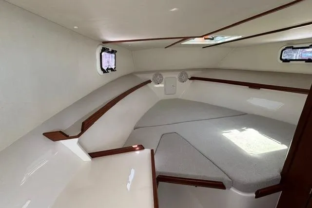 Slide: The Image of Interior cabin of 2026 NorthCoast 285 HT boat, featuring cozy sleeping area. - 8
