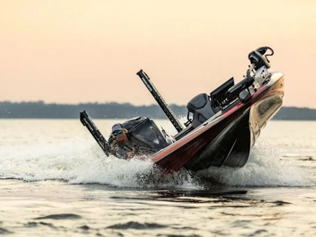 Slide: The Image of 2026 Skeeter FXR20 Apex boat navigating choppy waters at sunset. - 15