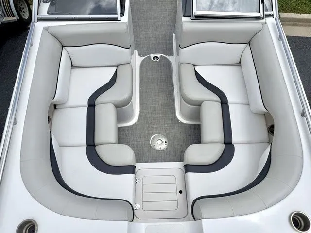 Slide: The Image of Interior of a 2015 Starcraft 210 I/O SCX boat with gray and white seating. - 11
