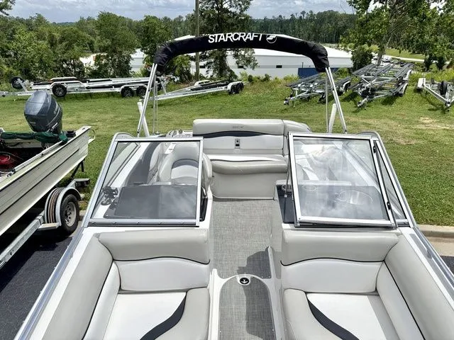 Slide: The Image of 2015 Starcraft 210 I/O SCX boat with gray upholstery and bimini top. - 12