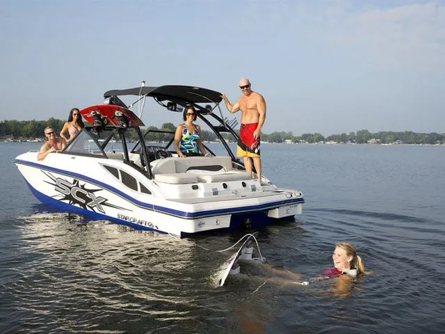 Slide: The Image of Starcraft 210 I/O SCX boat with people enjoying watersports, 2015 model. - 15