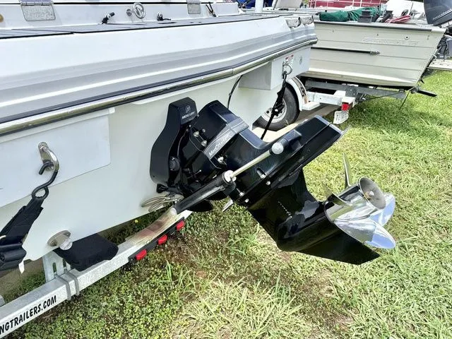 Slide: The Image of 2015 Starcraft 210 I/O SCX boat with outboard motor on trailer. - 4