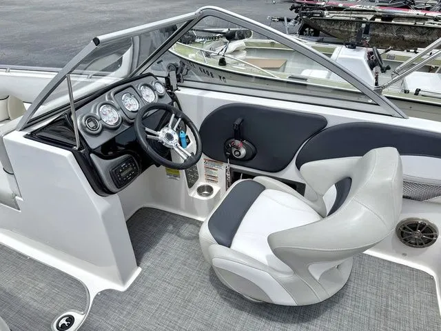 Slide: The Image of Interior view of a 2015 Starcraft 210 I/O SCX boat with steering console. - 7