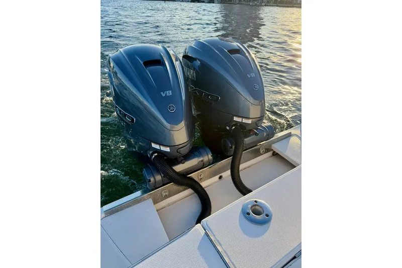Slide: The Image of Twin V8 outboard engines on a 2008 Jupiter 38 FS boat, cruising on water. - 12