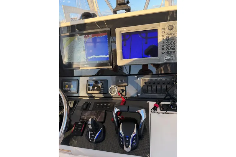 Slide: The Image of 2008 Jupiter 38 FS boat dashboard with navigation screens and controls. - 13