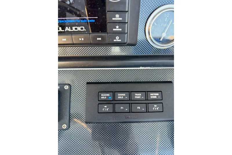Slide: The Image of Control panel of a 2008 Jupiter 38 FS boat with navigation buttons. - 15