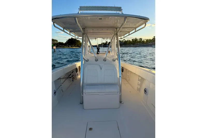 Slide: The Image of 2008 Jupiter 38 FS boat on water, featuring spacious deck and seating under canopy. - 4