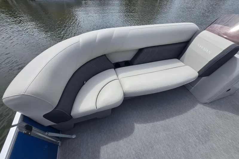 Slide: The Image of Luxurious seating on 2022 Sylvan 8522 Mirage Cruise pontoon boat by the water. - 12