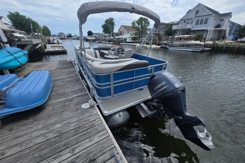 Slide: The Image of 2022 Sylvan 8522 Mirage Cruise pontoon boat docked with Yamaha outboard motor. - 3