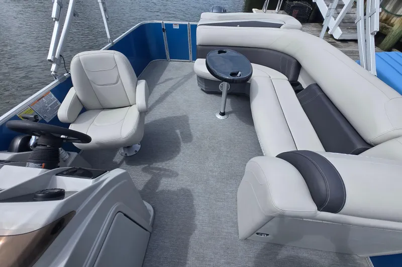 Slide: The Image of 2022 Sylvan 8522 Mirage Cruise pontoon boat interior with seating and steering console. - 4