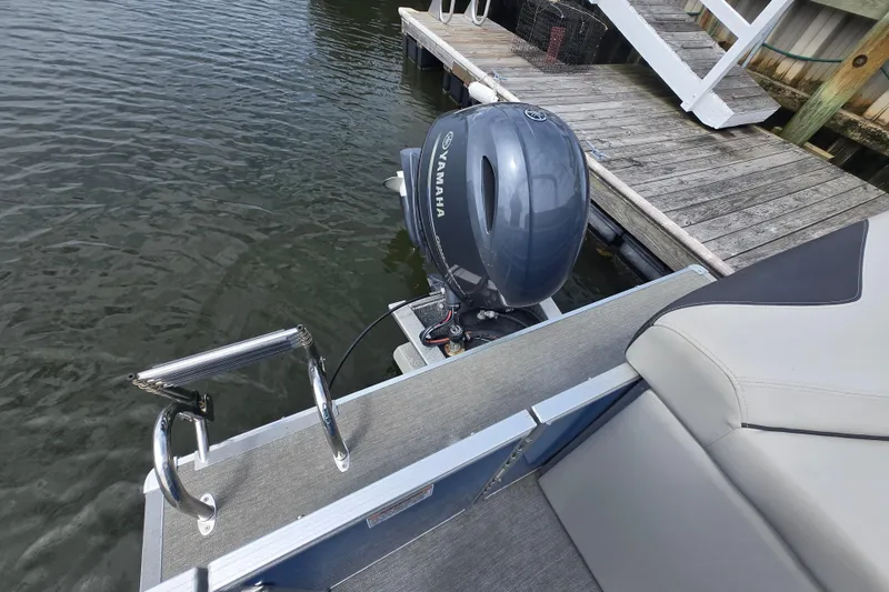 Slide: The Image of 2022 Sylvan 8522 Mirage Cruise with Yamaha outboard motor docked by wooden pier. - 6