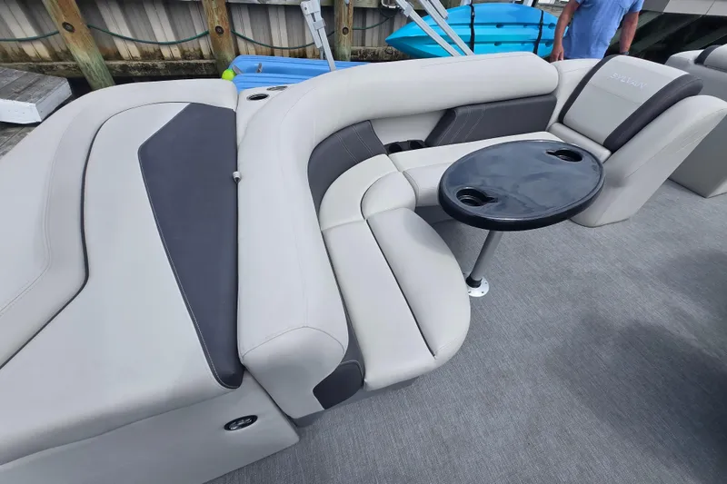Slide: The Image of 2022 Sylvan 8522 Mirage Cruise boat interior with plush seating and a round table. - 7