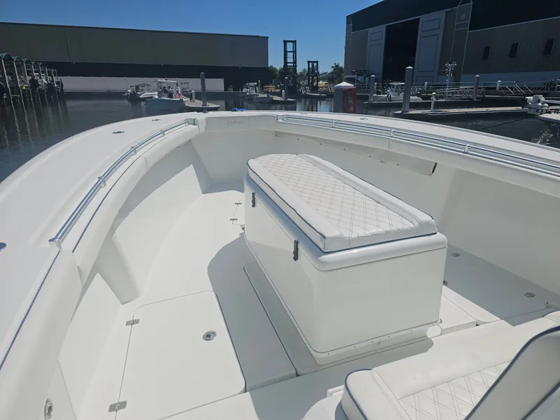 Slide: The Image of 2017 Yellowfin 39 Offshore boat with cushioned seating at the dock. - 1