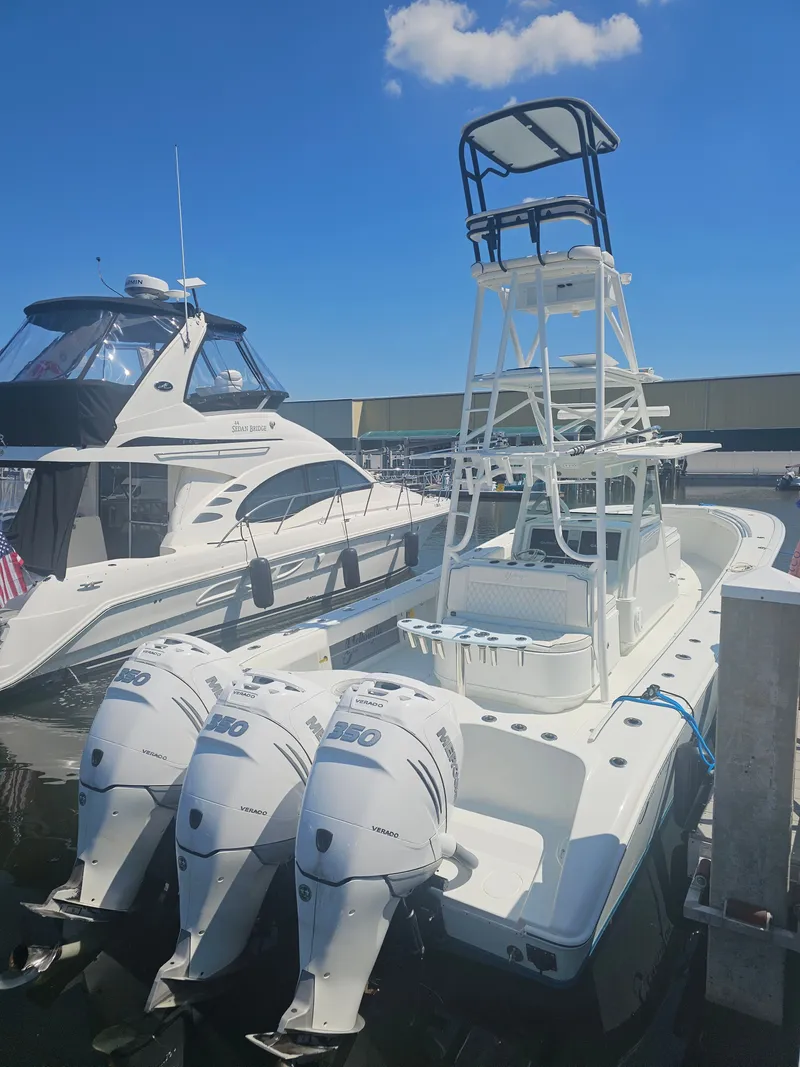 Slide: The Image of 2017 Yellowfin 39 Offshore boat with triple outboard engines docked. - 17