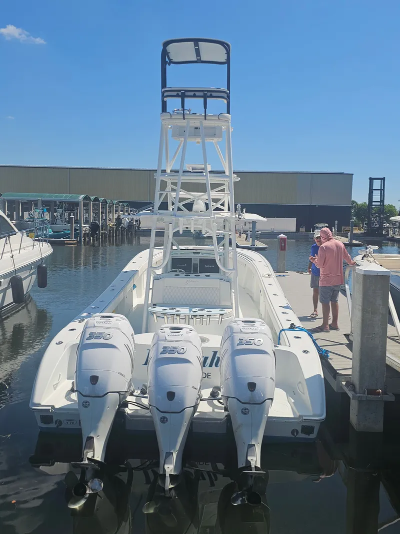 Slide: The Image of 2017 Yellowfin 39 Offshore boat with triple outboard engines at the dock. - 18
