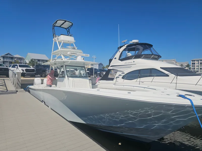 Slide: The Image of 2017 Yellowfin 39 Offshore boat docked under sunny skies. - 6