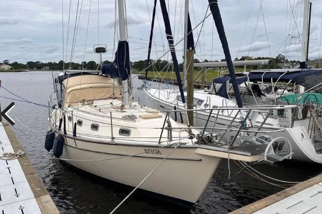 The Image of 1989 Island Packet 35 sailboat docked at marina, featuring classic design and beige hull. - 0