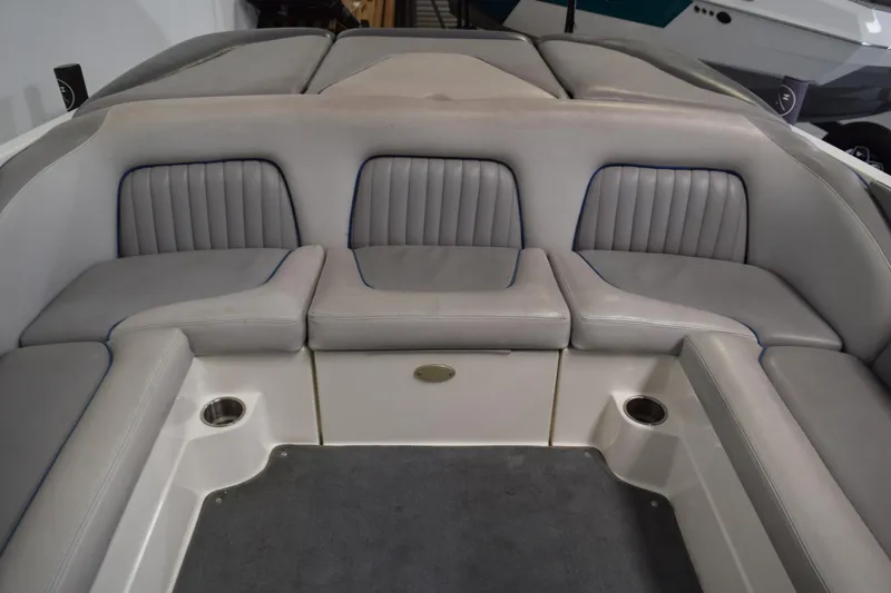 Slide: The Image of 2007 Centurion SV 240 boat interior with gray cushioned seating and cup holders. - 14