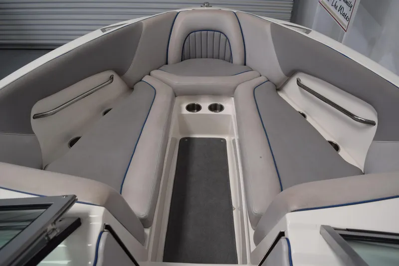 Slide: The Image of Interior of a 2007 Centurion SV 240 boat with cushioned seating and cup holders. - 19