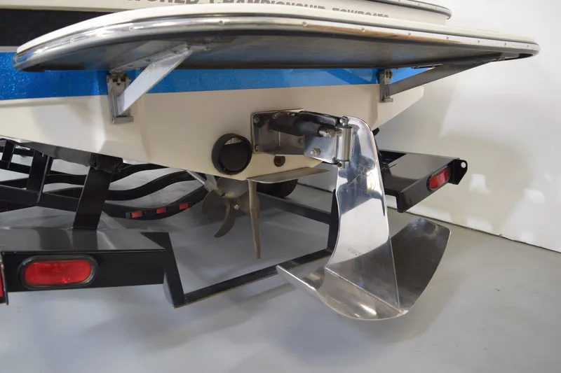 Slide: The Image of Rear view of a 2007 Centurion SV 240 boat on a trailer, showcasing the propeller and rudder. - 7