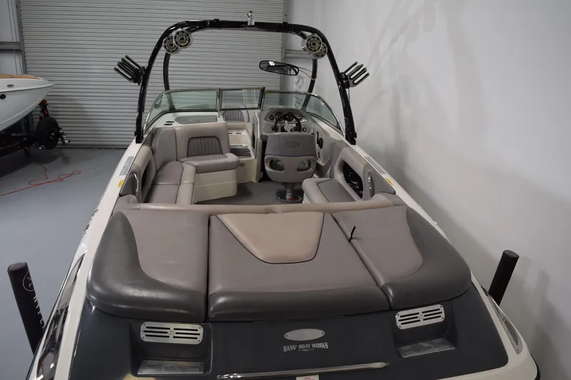 Slide: The Image of 2007 Centurion SV 240 boat interior with seating and steering wheel in a garage setting. - 9