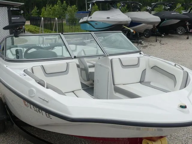 Slide: The Image of 2018 Yamaha SX190 boat with white interior, parked on gravel. - 13