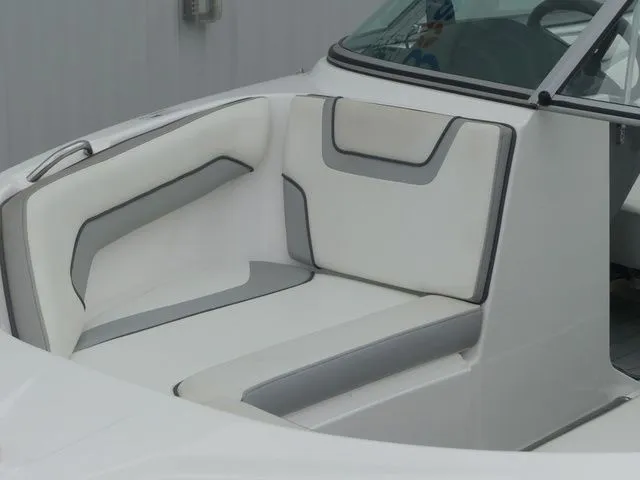 Slide: The Image of Interior of a 2018 Yamaha SX190 boat with white and gray seating. - 16