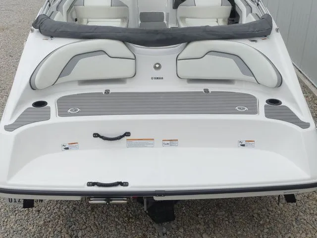 Slide: The Image of Rear view of a 2018 Yamaha SX190 boat with gray upholstery. - 24