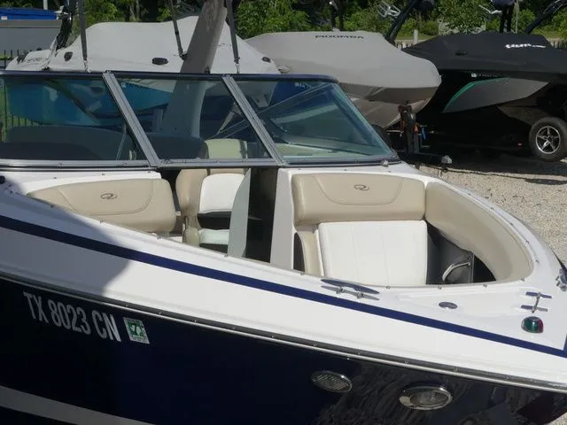 Slide: The Image of 2015 Regal 2500 boat, blue and white, parked at marina. - 12