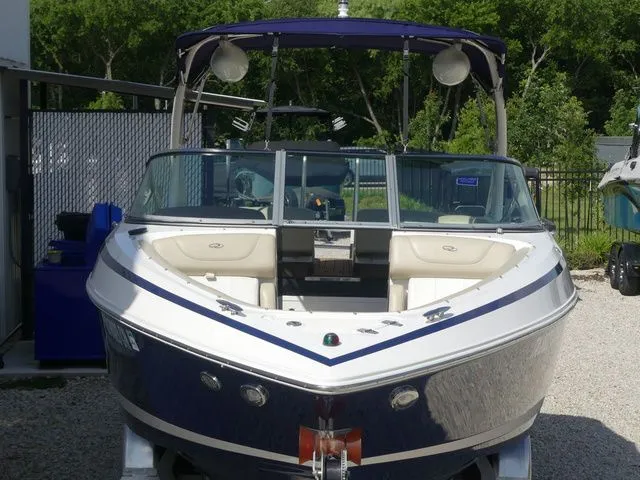 Slide: The Image of 2015 Regal 2500 boat, blue and white, parked outdoors. - 19