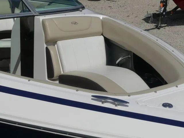Slide: The Image of Interior of a 2015 Regal 2500 boat with beige and white seating. - 21