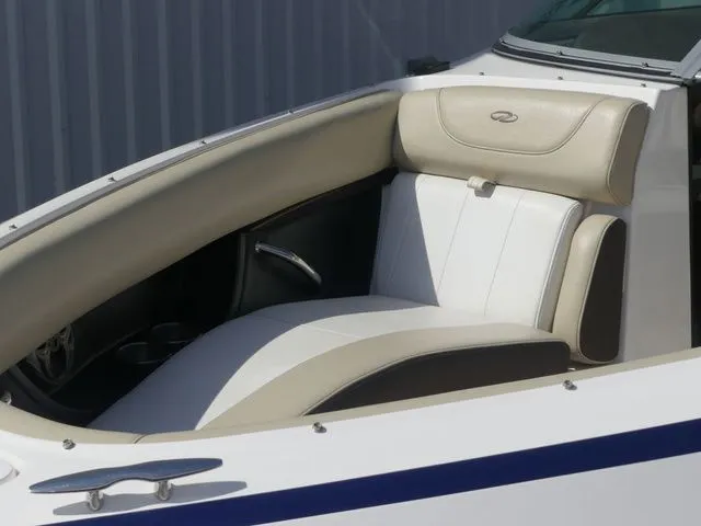 Slide: The Image of Interior of a 2015 Regal 2500 boat with beige and white seating. - 23