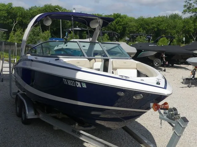 Slide: The Image of Blue and white 2015 Regal 2500 boat on trailer. - 4