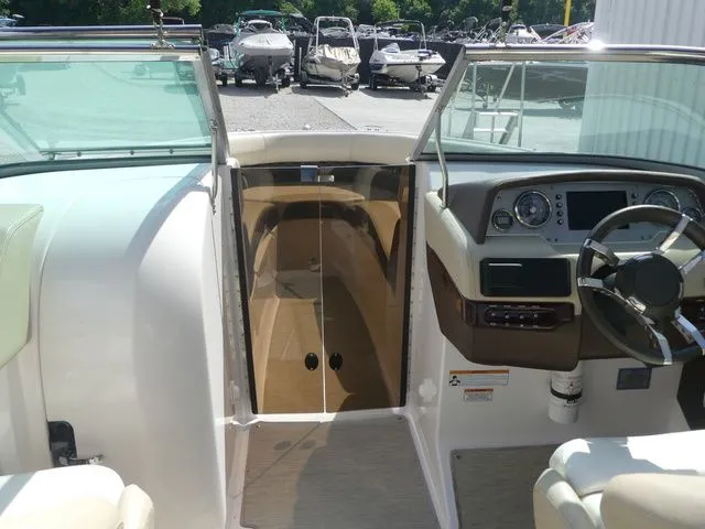 Slide: The Image of Interior view of a 2015 Regal 2500 boat with steering console. - 43