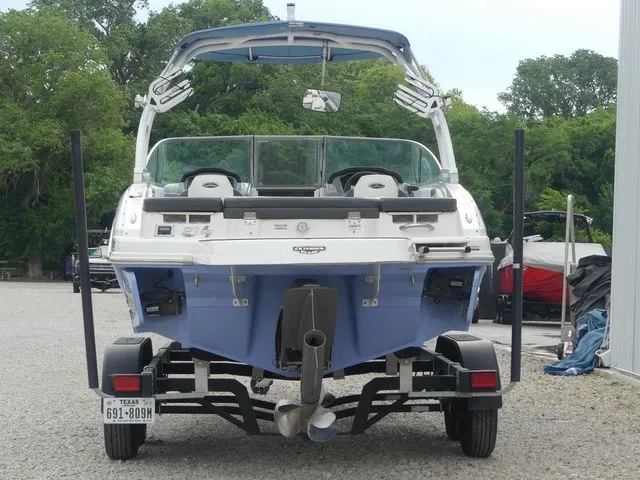 Slide: The Image of Rear view of a 2023 Chaparral 21 Surf boat on a trailer. - 10