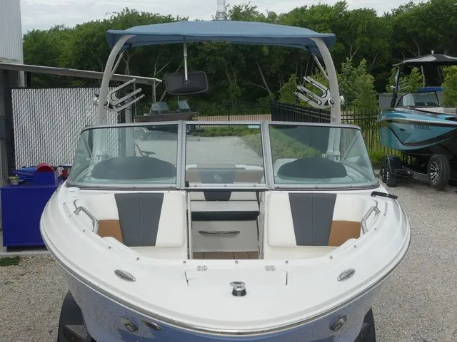 Slide: The Image of 2023 Chaparral 21 Surf boat with blue canopy and modern features. - 19