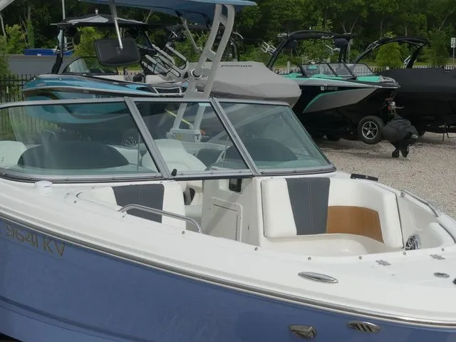 Slide: The Image of 2023 Chaparral 21 Surf boat parked at a marina. - 20