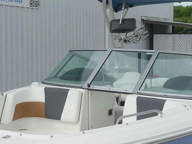 Slide: The Image of 2023 Chaparral 21 Surf boat with sleek design and comfortable seating. - 22