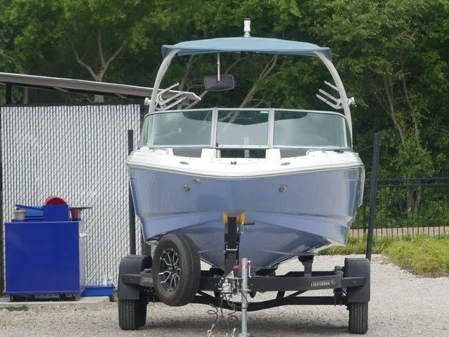 Slide: The Image of 2023 Chaparral 21 Surf boat on trailer, front view. - 3