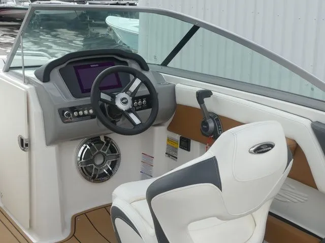 Slide: The Image of Interior of 2023 Chaparral 21 Surf with steering console and seat. - 35