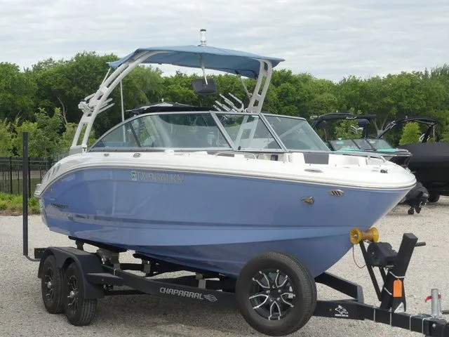 Slide: The Image of 2023 Chaparral 21 Surf boat on trailer, blue and white. - 4
