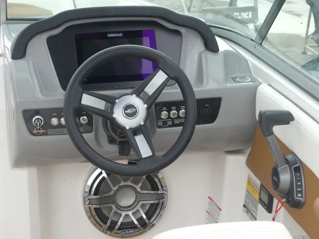 Slide: The Image of Cockpit of 2023 Chaparral 21 Surf with steering wheel and controls. - 45